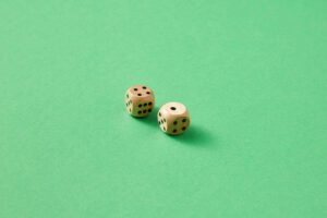 Two dice are laid against a green background.